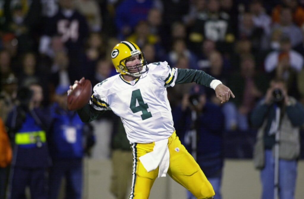 CHAMPAIGN, IL - OCTOBER 7: Quarterback Brett Favre #4 of the Green Bay Packers throws a long touchdown pass against the Chicago Bears during their game on October 7, 2002 at Memorial Stadium at the University of Illinois in Champaign, Illinois. The Packers won 34-21. (Photo by Jonathan Daniel/Getty Images)
